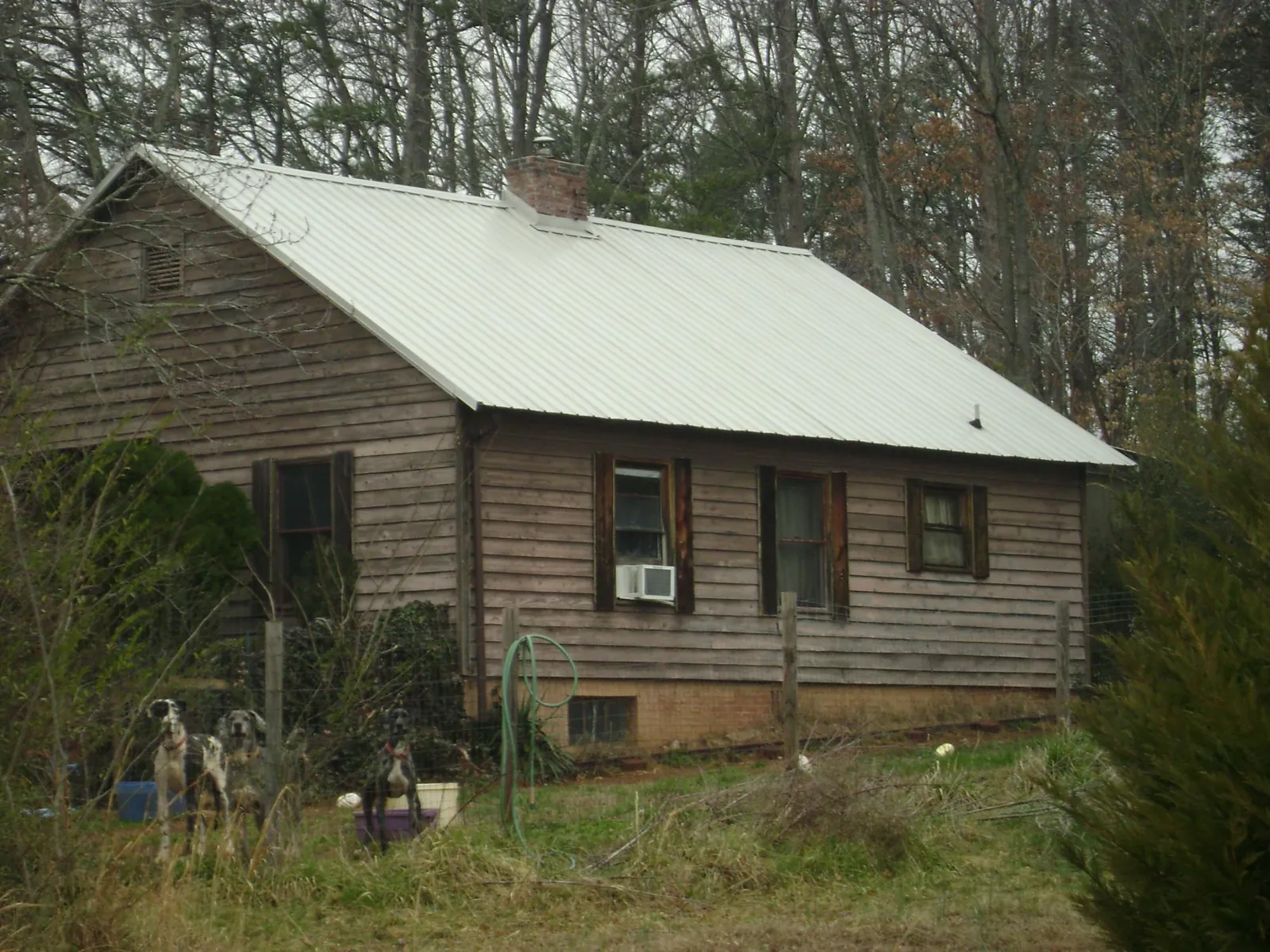 White metal roof on an old wood sided farmhouse, from a Metal Roof Installation job in Nesconset